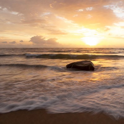 Large Rock in Ocean Waves at Sunset