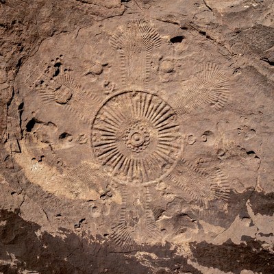 Ancient Carved Sun Symbol on Rock