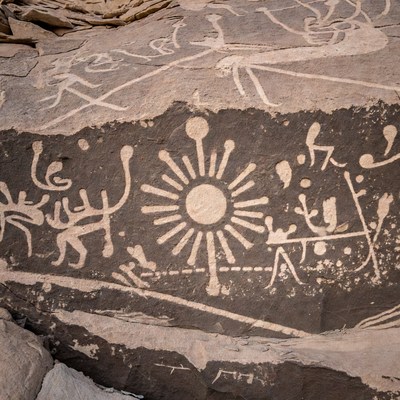 Ancient Rock Art with Sun and Figures