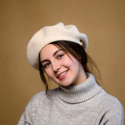 Smiling woman in beret and turtleneck