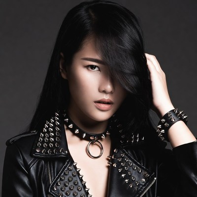 Asian woman in studded leather jacket