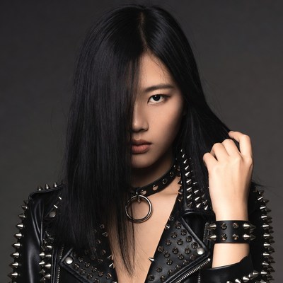 Asian woman in spiked leather jacket