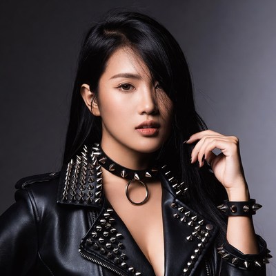 Asian woman in spiked leather jacket