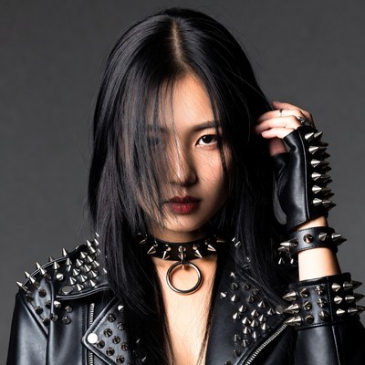 Asian woman in spiked leather punk outfit