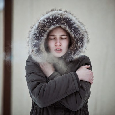 Woman shivering in fur hood jacket