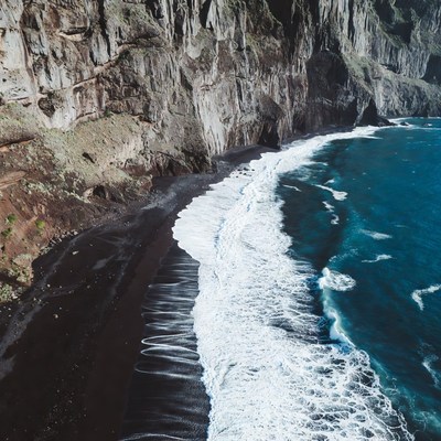 Black Sand Beach with Cliffs and Ocean Waves