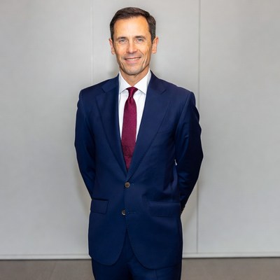 Man in navy suit smiling