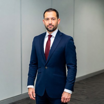 Man in navy suit with red tie