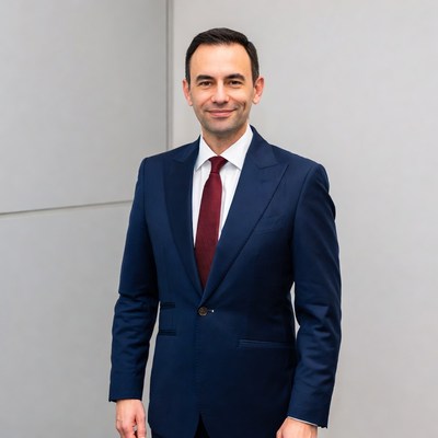 Man in navy suit smiling