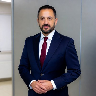 Man in navy suit with red tie