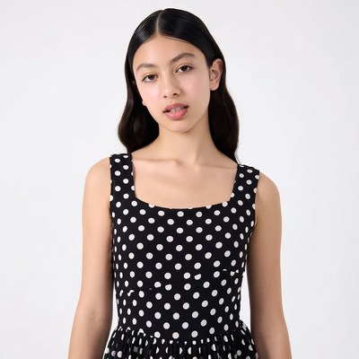 Asian girl in black polka dot dress