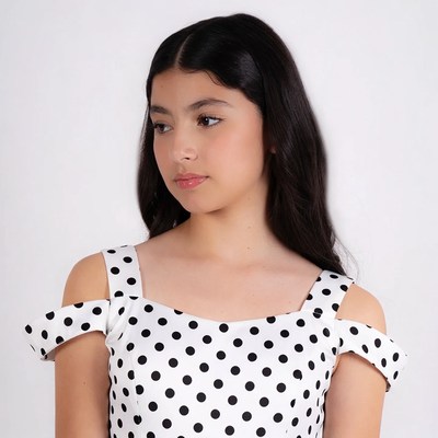 Latino girl in polka dot off-shoulder top