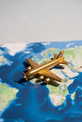 Golden airplane model on world map