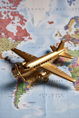Golden airplane on world map