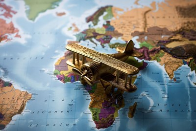 Brass biplane on world map