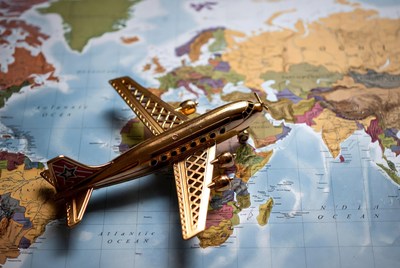 Golden Toy Airplane on World Map