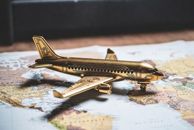 Golden Toy Airplane on World Map