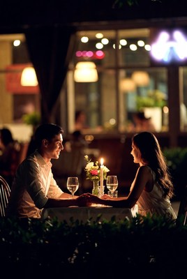 Romantic couple dining outdoors at night