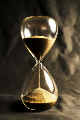 Golden Hourglass with Sand Flowing