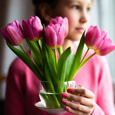Girl holding pink tulips
