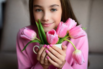 Girl holding pink tulips