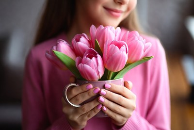Woman holding pink tulips