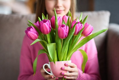 Woman holding pink tulips bouquet