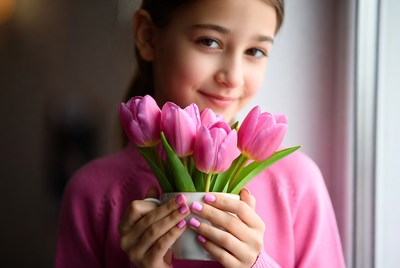 Girl holding pink tulips