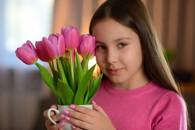 Girl holding pink tulips