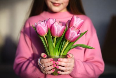 Girl holding pink tulips
