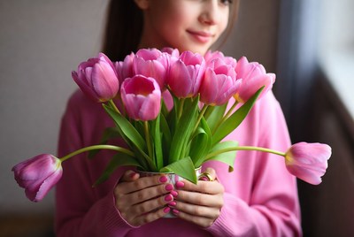 Woman holding pink tulips