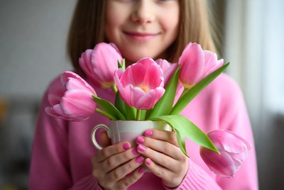 Girl holding pink tulips