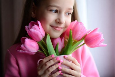 Girl holding pink tulips
