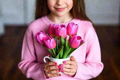 Girl holding pink tulips