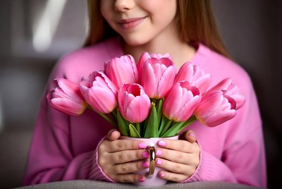 Girl holding pink tulips