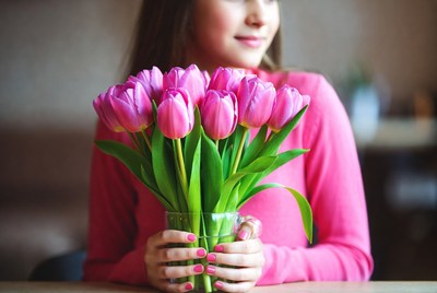 Woman holding pink tulips