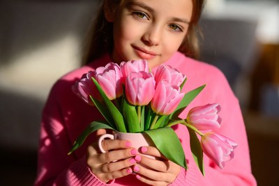 Girl holding pink tulips