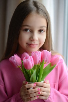 Girl holding pink tulips