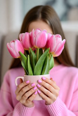 Woman holding pink tulips