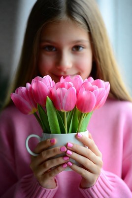 Girl holding pink tulips