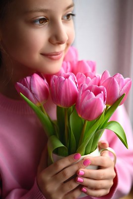 Girl holding pink tulips