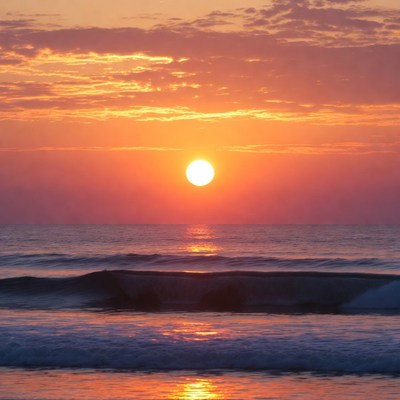 Sunrise over ocean waves