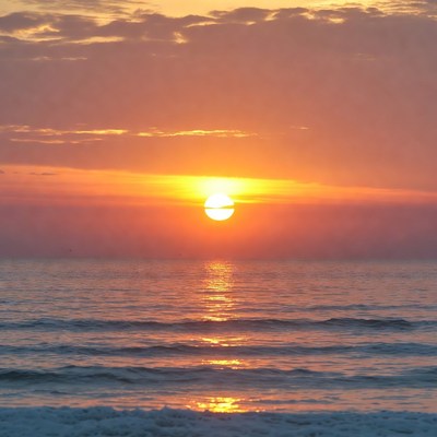 Sunrise over ocean waves