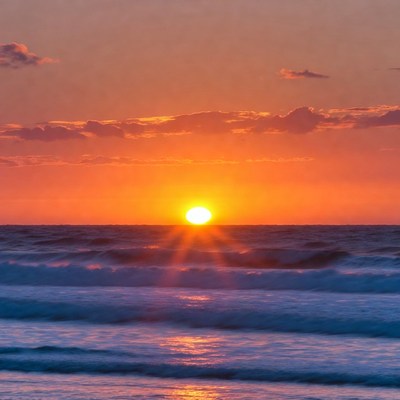 Sunset over ocean waves