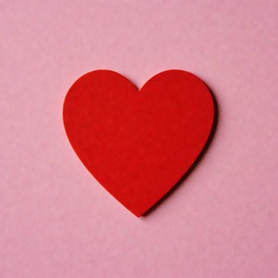 Red heart on pink background