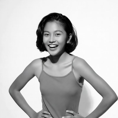 Asian girl smiling with hands on hips