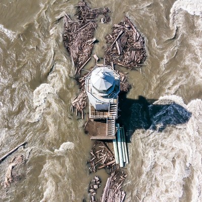 Lighthouse surrounded by river debris