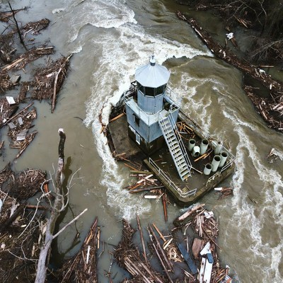 Debris-Covered Tugboat in Flooded River