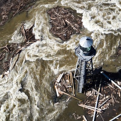 Lighthouse amid flooded river debris