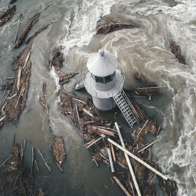 Lighthouse amid flood debris